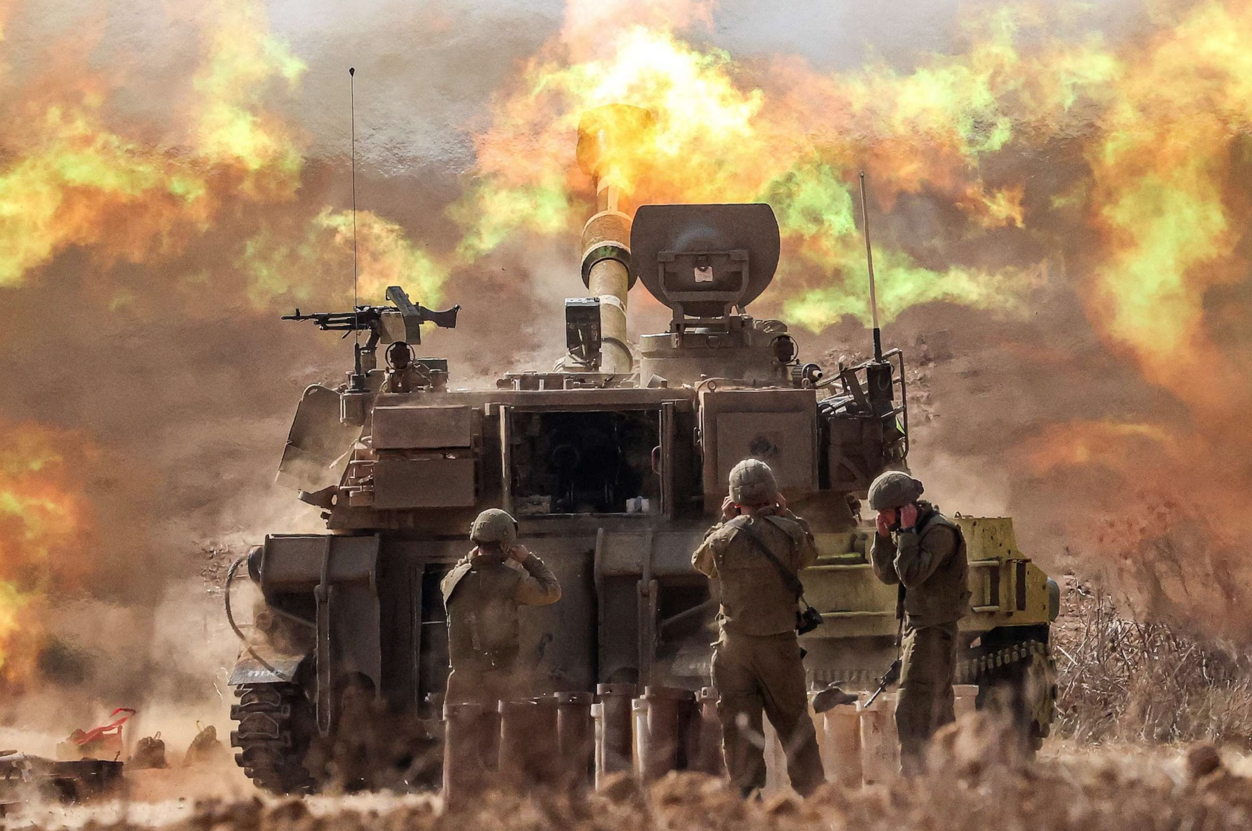 An Israeli army self-propelled howitzer fires shells near the Gaza border in southern Israel, October 11, 2023